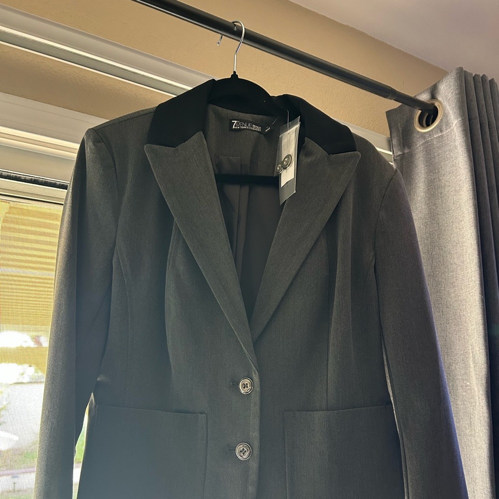 Brand new jacket blazer with black collar.